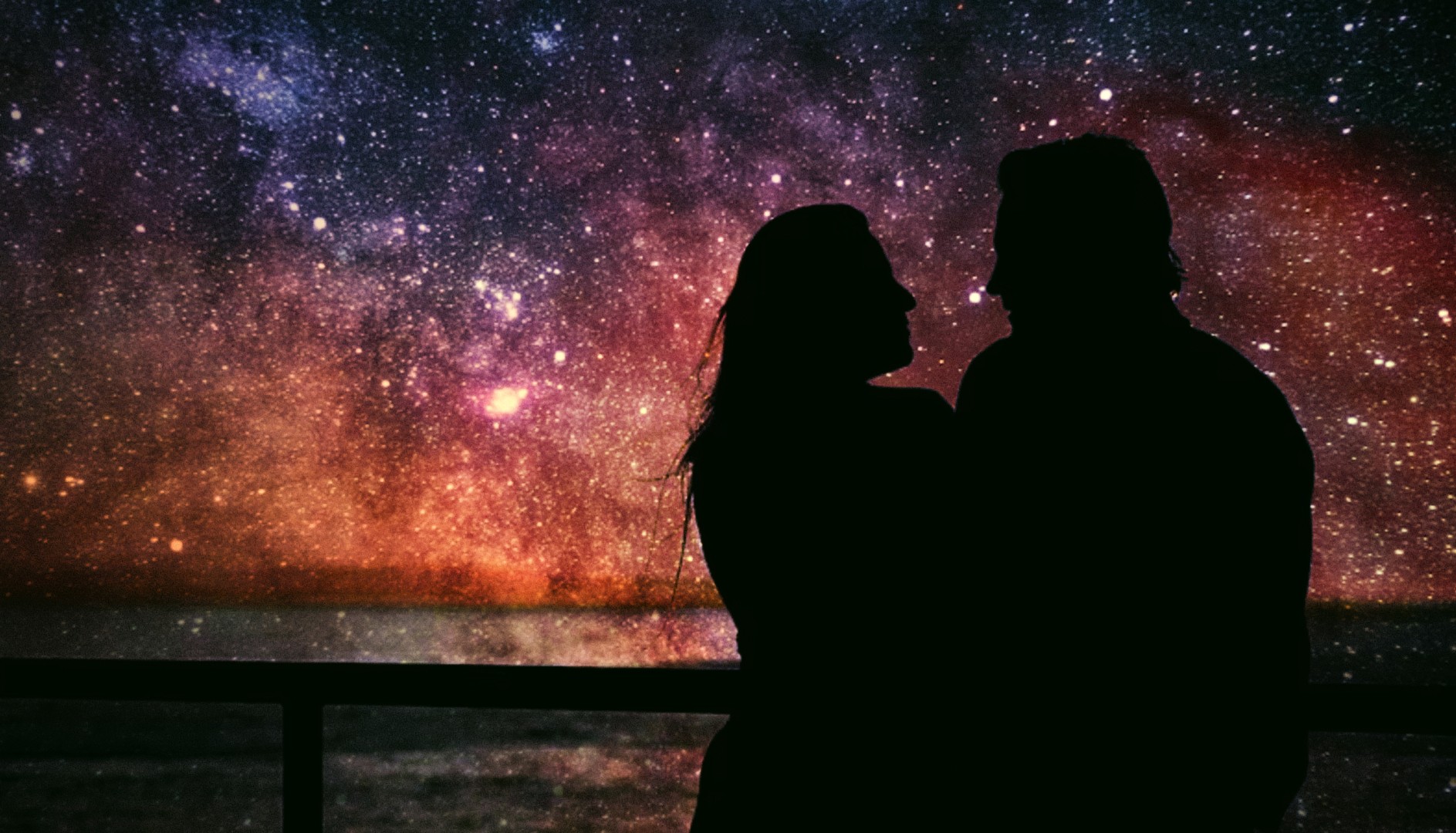 Silhouettes of a man and woman under starry sky